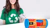 A woman in a green t-shirt with a recycling logo holds crumpled paper, next to a roll of trash bags. Podgląd zdjęcia produktu