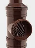 A close-up studio shot of a brown drainpipe fitting with a grate. Náhľad obrázku produktu