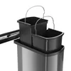 A close-up view of a multi-compartment trash can insert with black bins and silver handles, set against a white background. Voir les images du produit