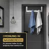 A bathroom scene with towels hanging on a door hook. Produktbild-Vorschau