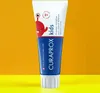 A tube of Curaprox kids toothpaste against an orange and yellow background. Anteprima dell’immagine prodotto