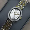 A close-up shot of a women's watch on a gray surface. Náhled obrázku produktu