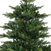 A close-up view of the branches and needles of an artificial Christmas tree. Voir les images du produit