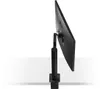 The back side of a black LG monitor mounted on a black stand, clamped to a white surface. Produktbild-Vorschau