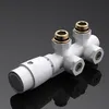 A white radiator valve with gold fittings is shown against a dark gray background with a reflection. Produktbild-Vorschau