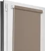 A close-up view of a roller blind installed in a window frame.