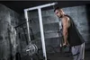 A man is performing a triceps exercise using a cable machine in a gym. Náhľad obrázku produktu