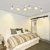 A bedroom with a bed, a sliding door, and a ceiling light. Produktbild-Vorschau