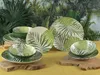 A set of tropical-themed tableware with palm leaf patterns is displayed on a yellow surface, with a lush green jungle backdrop. Náhľad obrázku produktu