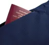 A passport is partially inserted into a navy blue zippered pocket. Anteprima dell’immagine prodotto