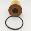A car oil filter and a rubber gasket on a white background. Voir les images du produit