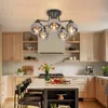 A modern kitchen with light wood cabinets, a white island with bar stools, and a ceiling light fixture. Produktbild-Vorschau