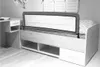 A bed with a bed rail and a small desk next to it. Produktbild-Vorschau