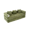 A green modular sofa bed with three pillows, shown from a side angle on a white background. Voir les images du produit