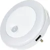A white LED night light with a motion sensor and two USB charging ports. Produktbild-Vorschau