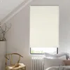 A room interior with a window covered by a beige pleated blind, a wooden chair with books, and a radiator. Produktbild-Vorschau