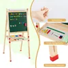 A collage of images showing a wooden easel with a blackboard and whiteboard, accessories, and close-ups of features. Produktbild-Vorschau