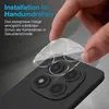 A hand is shown applying a clear camera lens protector to the back of a smartphone. Produktbild-Vorschau