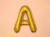 A single gold letter 'A' balloon on a pink background with scattered gold confetti. Podgląd zdjęcia produktu