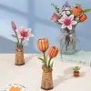 A collection of 3D wooden flower puzzles, including lilies and tulips, arranged on a surface with a blue background. Podgląd zdjęcia produktu