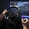 A person's hands are shown gripping a racing steering wheel and gear shifter, playing a racing video game on a monitor. Náhľad obrázku produktu