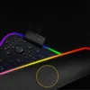 A close-up view of a gaming mousepad with RGB lighting and water droplets on its surface. Produktbild-Vorschau