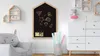 A child's room with a house-shaped chalkboard, a stuffed animal chair, and a dresser. Produktbild-Vorschau