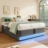 A modern bedroom with a bed featuring LED lighting and integrated charging ports. Produktbild-Vorschau