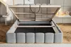 A bed frame with its storage compartment open, revealing the slatted base and storage space. Náhled obrázku produktu
