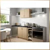 A small kitchen setup with cabinets, sink, and stove. Voir les images du produit