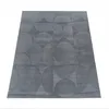 A grey rug with a geometric pattern of circles and squares, laid flat on a white background. Anteprima dell’immagine prodotto