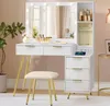 A white vanity table with a lighted mirror, drawers, and a stool, set in a room with a textured wall and a side table. Produktbild-Vorschau