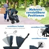 A woman pushing a double stroller with two babies in a park. Podgląd zdjęcia produktu