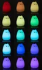 A collage of multiple cat-shaped LED night lights in various colors against a black background. Produktbild-Vorschau