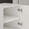 Close-up view of the interior of a white cabinet, showing shelves and hinges. Produktbild-Vorschau
