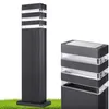 Two black bollard lights are shown against a white background with a patch of green grass at the bottom. Náhľad obrázku produktu