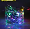 A string of colorful LED lights submerged in water inside a clear glass. Produktbild-Vorschau