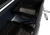 Close-up view of the interior of a black charcoal grill, showing two perforated metal trays. Produktbild-Vorschau