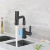 A modern kitchen sink with a black faucet and running water. Náhled obrázku produktu