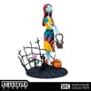 A collectible figure of Sally from The Nightmare Before Christmas, standing on a diorama base with Halloween-themed elements. Podgląd zdjęcia produktu