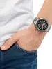 A person's wrist wearing a watch, with their hand in their pocket. Produktbild-Vorschau