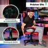 A man is sitting in a red and black gaming chair in a room with gaming equipment and colorful lighting. Náhľad obrázku produktu