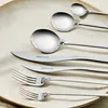 A set of silverware laid out on a plate. Voir les images du produit