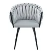 A light gray velvet armchair with a knot design and black metal legs, presented on a white background. Produktbild-Vorschau