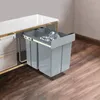 A pull-out trash can system with two compartments inside a kitchen cabinet. Voir les images du produit