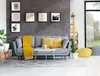 A living room scene with a gray sofa, yellow accents, and artwork on the wall. Náhled obrázku produktu