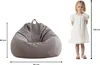 A bean bag chair is shown next to a child to indicate its size. Voir les images du produit