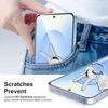 A hand places a smartphone into a jeans pocket, with keys inside the pocket and on the phone's screen. Produktbild-Vorschau