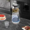 A kitchen counter with a glass kettle, a cake, a glass of water, and a steak. Náhled obrázku produktu