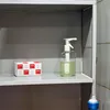 A shelf with a box of paper towels and a soap dispenser. Náhled obrázku produktu